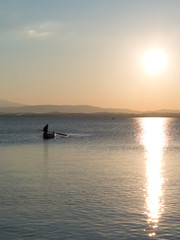 Naklejka na ściany i meble Fisherman on the Lake at Dusk