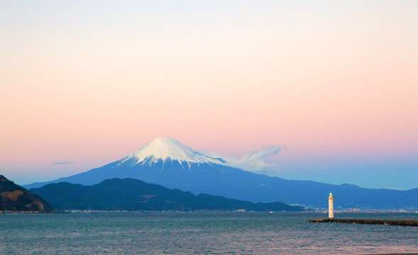 Mount Fuji and a light house seen from the beach