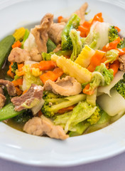 Stir fried mixed vegetables with pork on white plates