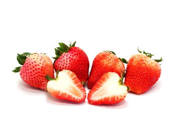 Fresh ripe strawberries and  slice  on white background