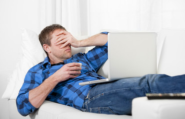 Young attractive man with headache and stress using Computer