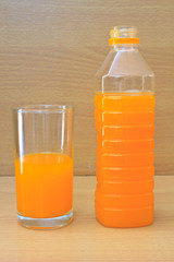 Orange juice in plastic bottle and glass
