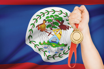 Medal in hand with flag on background - Belize