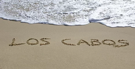 Fotobehang los cabos written on a wet beach © gdvcom