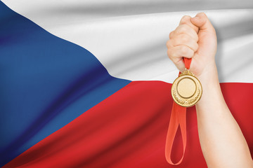 Medal in hand with flag on background - Czech Republic