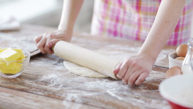 close up of female working with rolling-pin