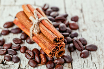 stack of cinnamon sticks and coffee beans