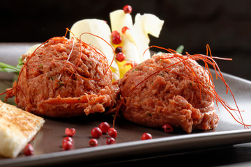 Tasty beef tartare with toast bread and butter