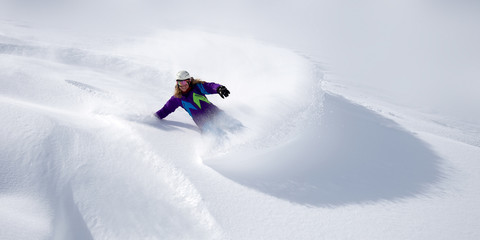 Snowboarderin im Tiefschnee
