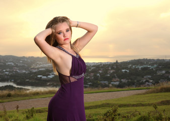 Attractive blonde lady on hill over town