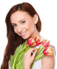 Young woman is holding bouquet of tulips