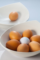 White bowls, easter eggs and golf balls