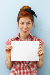 Pin-Up Girl holding blank card with copy space