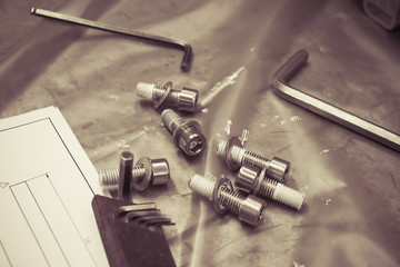 bolts, screws and nuts on table - colorized photo