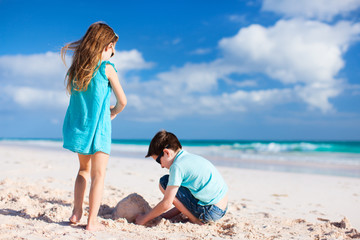 Two kids playing with sand