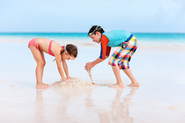 Fototapeta na wymiar Two kids playing with sand