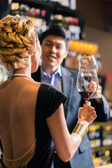Asian couple drinking red wine