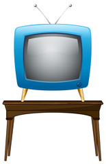 A blue television above the wooden table