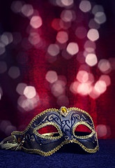 Carnival mask on a background of holiday lights.