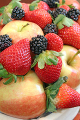Close-up of ripe apples, strawberries, and blackberries