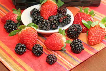 A bowl of fresh strawberries and blackberries