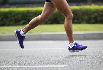 marathon runner running at city street