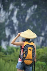 Muurstickers woman hiker hiking in the guilin scenery,china © lzf