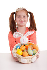 Fototapeta na wymiar beautiful little red-haired girl with pigtails holding Easter eg