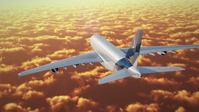 Jet flying over cloudscape at sunset