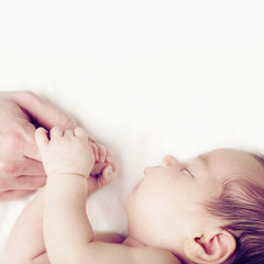 Baby and fathers hand, parental love