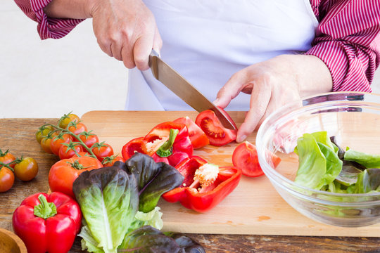 Man cutting vegetables for healthy salad