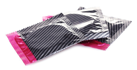 Three packs of condoms isolated on white