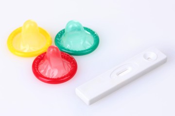 birth condoms and pregnancy test isolated on white