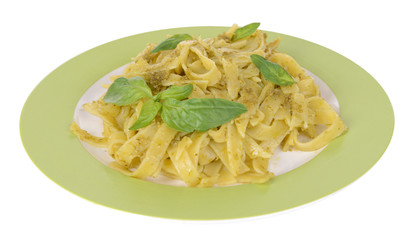 Delicious pasta with pesto on plate isolated on white