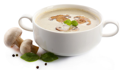 Mushroom soup in white bowl, on plate, isolated on white