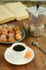Cup of black coffee and dried kumquats
