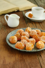 Dried kumquats on rusted metal plate