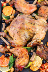 Whole roasted chicken with vegetables on tray, close-up