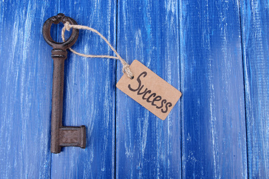 Key to success, Conceptual photo. On color wooden background
