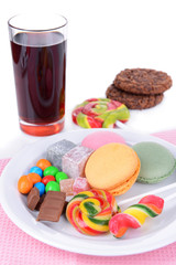 Different sweets on plate on table close-up