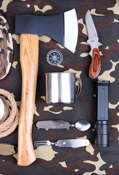 Equipment for trekking on camouflage background