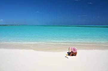 Foto op Plexiglas Girl with a glass of orange on the beach of Exuma, Bahamas © HappyAlex