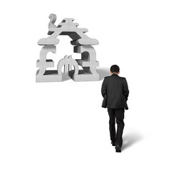 Man walking toward money stacking building