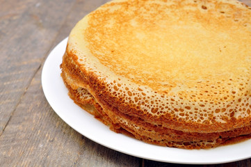 pancakes on a plate on a wooden table