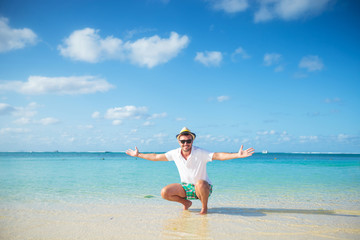 Fototapeta na wymiar casual man welcoming you to the beach of mauritius