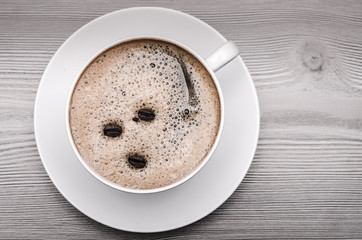 Cup of coffee on wooden surface