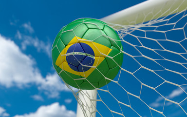 Brazil flag and soccer ball in goal net