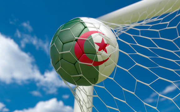 Algeria flag and soccer ball in goal net