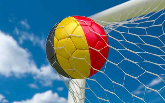 Belgium flag and soccer ball in goal net