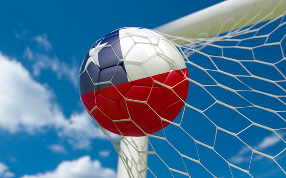 Chile flag and soccer ball in goal net